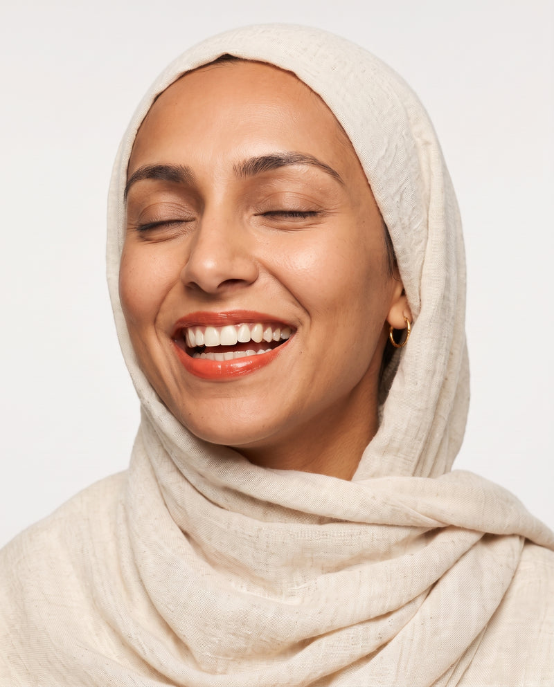 Amira laughing, wearing Bird of Paradise tinted lip balm