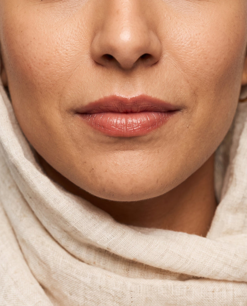 Close-up of Amira wearing Blushing Bride tinted lip balm