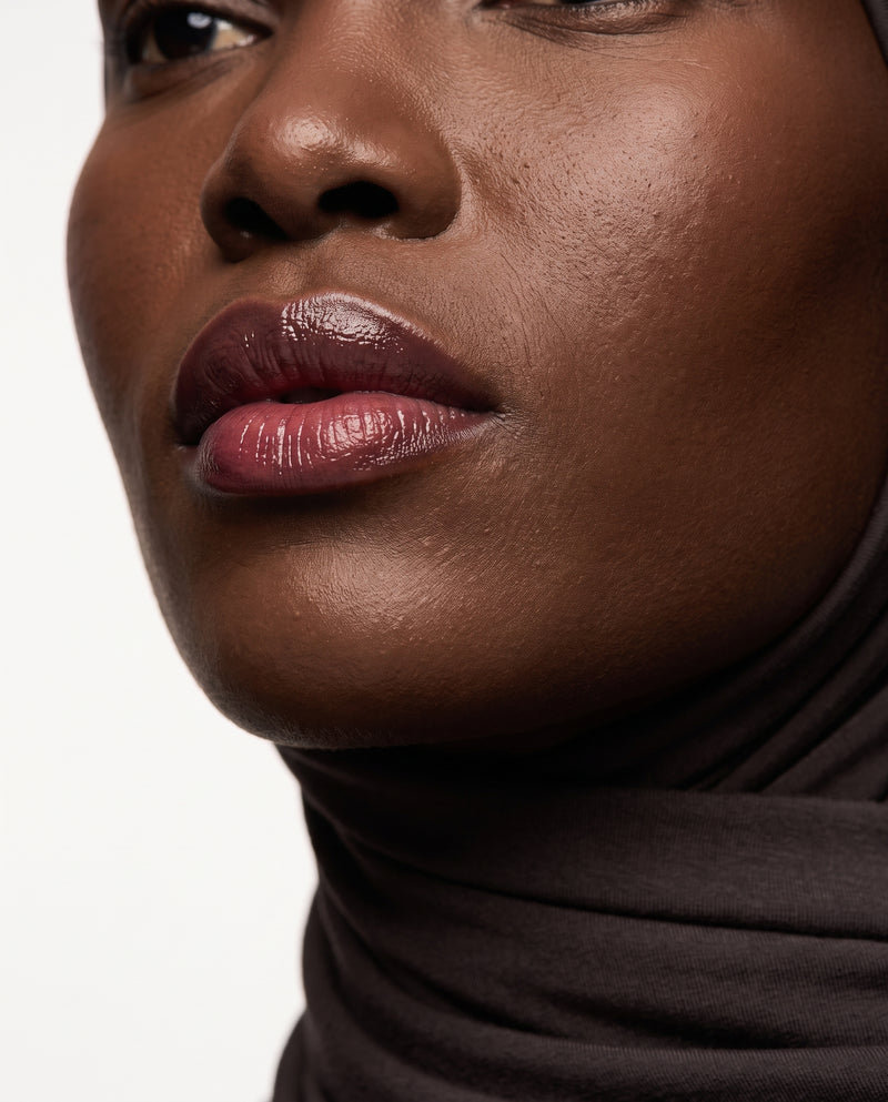 Close-up of Noor wearing Morning Glory tinted lip balm
